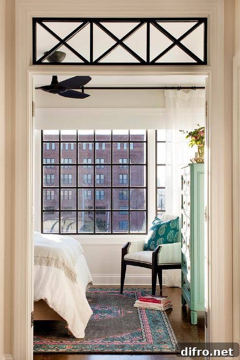 Bedroom with transom window inviting natural light highlighting vintage style decor and furnishings.