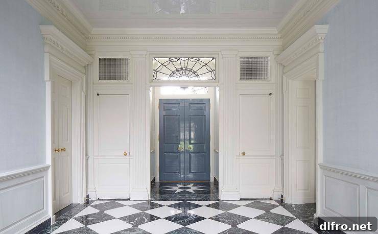 Black and white marble harlequin floor tiles lead to a vestibule boasting a leaded glass transom window.