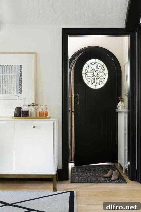 Black plank arch front door with a stained glass panel.