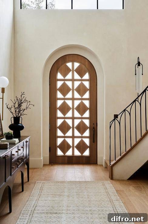 An arched front door finished with diamond wood panels.