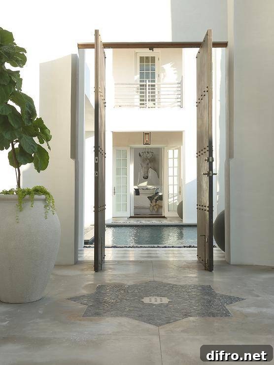 Moroccan style floor tiles lead through industrial pivot doors.