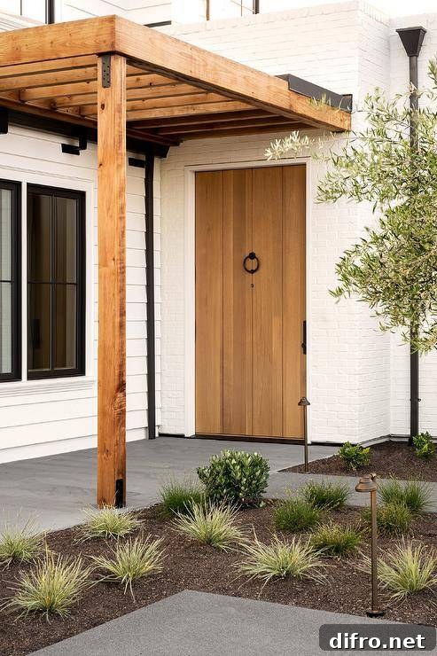 A home features a plank front door with a bronze ring door knocker.