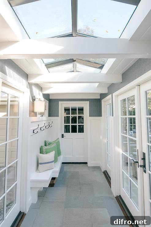 Sunroom with skylights, bench and layered textiles