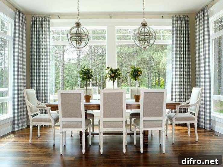 Dining room with trestle table, gray chairs and pendant lighting