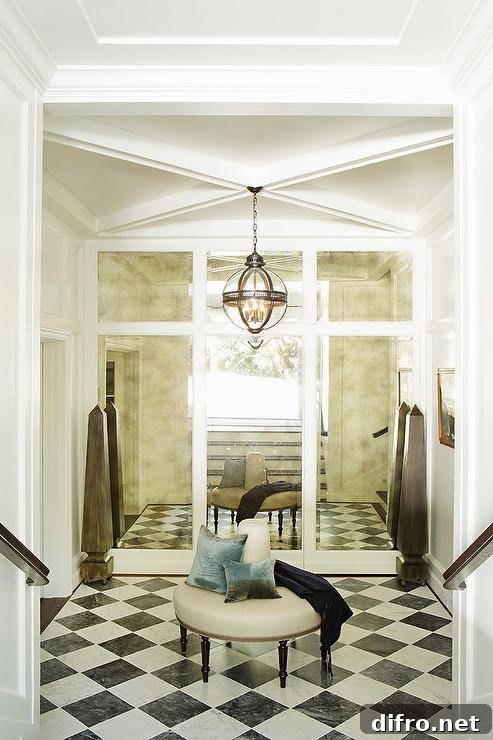 Black and white foyer with a pendant light and mirrored paneled wall.