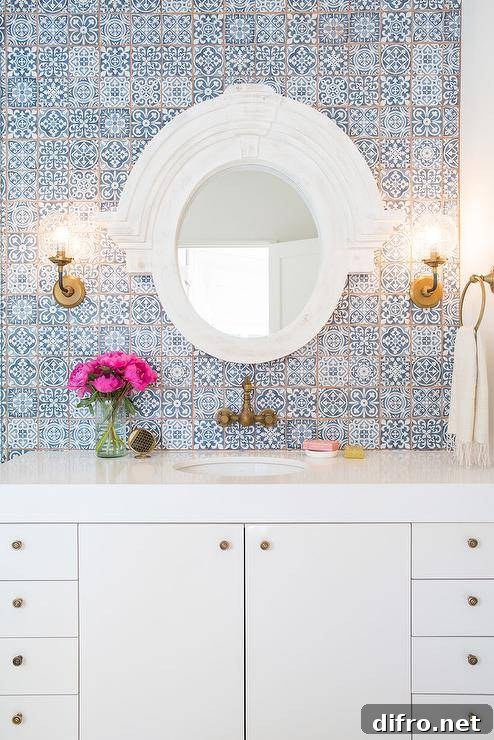 Bathroom featuring blue Moroccan-style tiles and a white lacquered washstand.