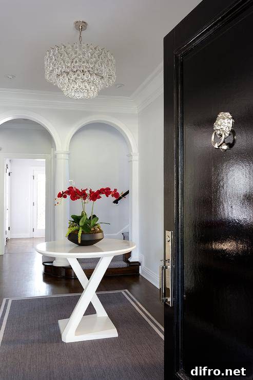 Entryway with small round table, rug and chandelier