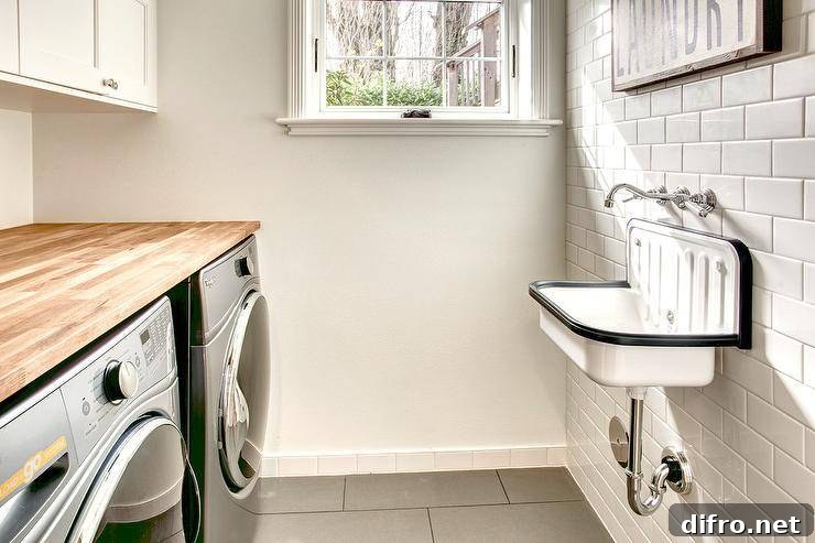 white subway tile wall mounted sink black and white butcher block counter top over stainless steel washer and dryer side by side