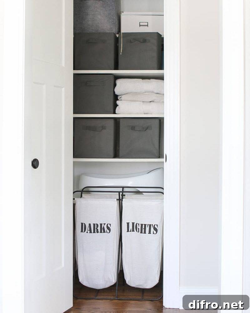 inside of bathroom linen closet with baskets and laundry separated hamper