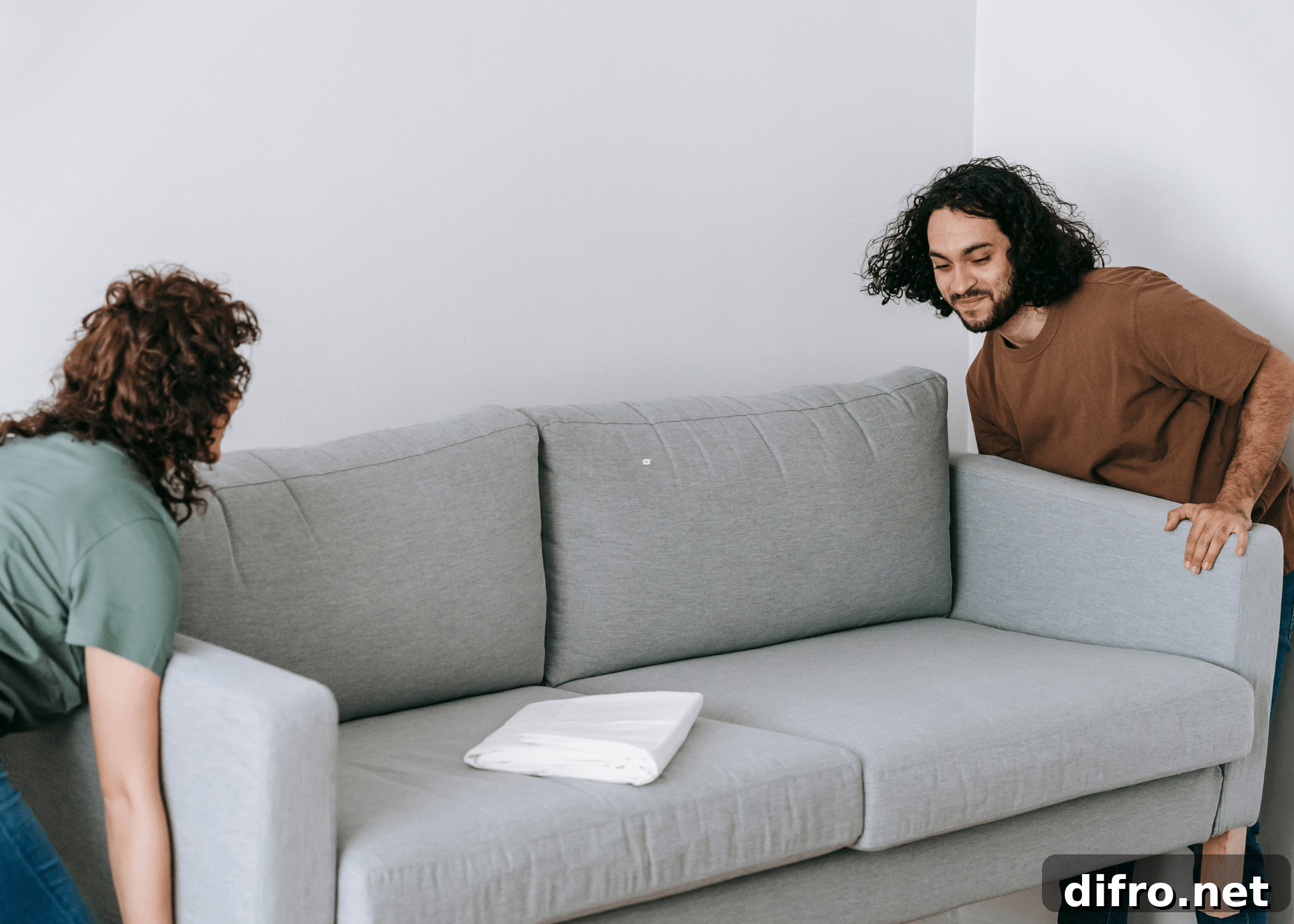 woman and man moving a couch