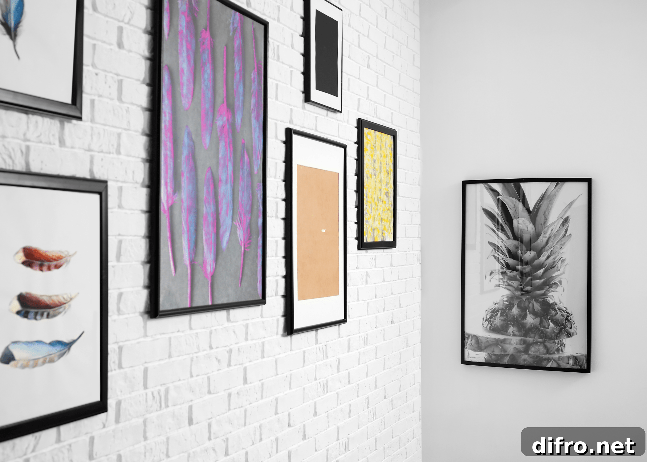 gallery wall of photos on white brick wall
