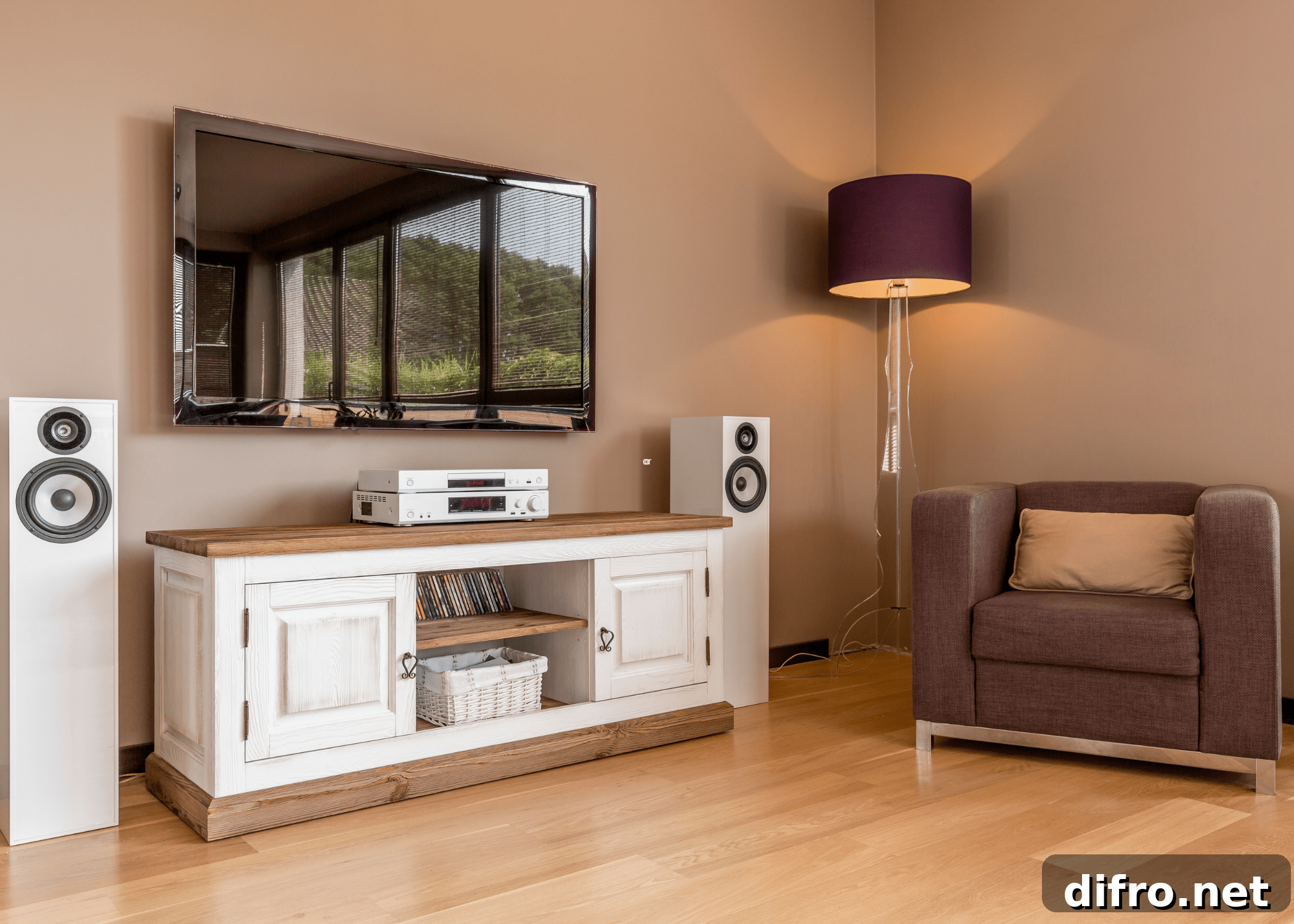 living room with tv console arm chair lamp and hanging tv