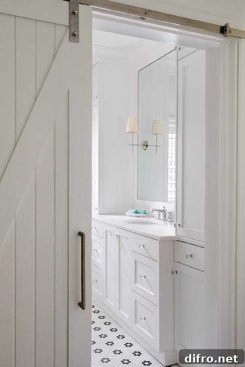 White shiplap barn doors slide open into a master bathroom.