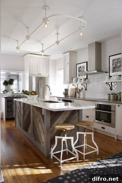 Stunning kitchen with gray paint color, Ikea kitchen cabinets with Silestone Grey Expo countertops, barnboard kitchen island with calcutta marble countertop, herringbone tile backsplash, white shelves flanking induction cooktop, white swivel stools from Morba, glass-front wine cooler and vintage shower enclosure lighting.