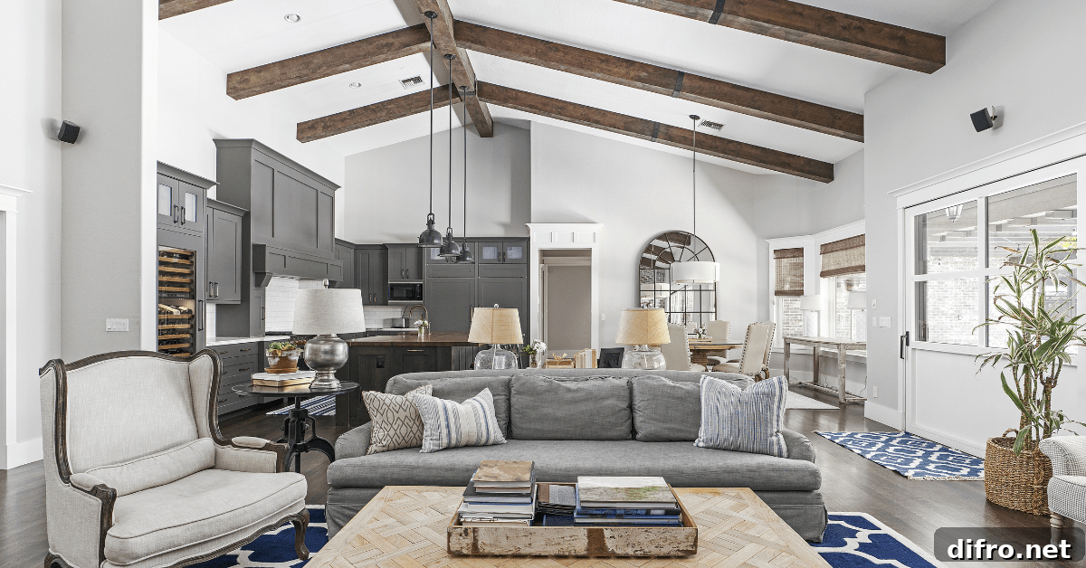 A neutral color living room with vaulted ceiling and wood beams.