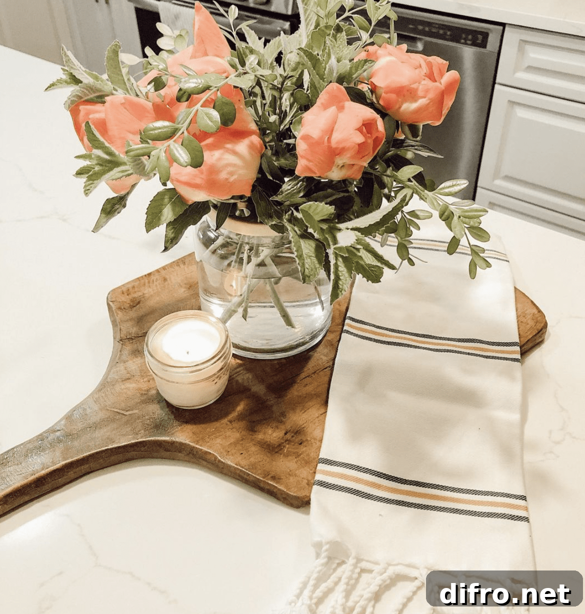 marble countertop with wood cutting board and flower arrangement