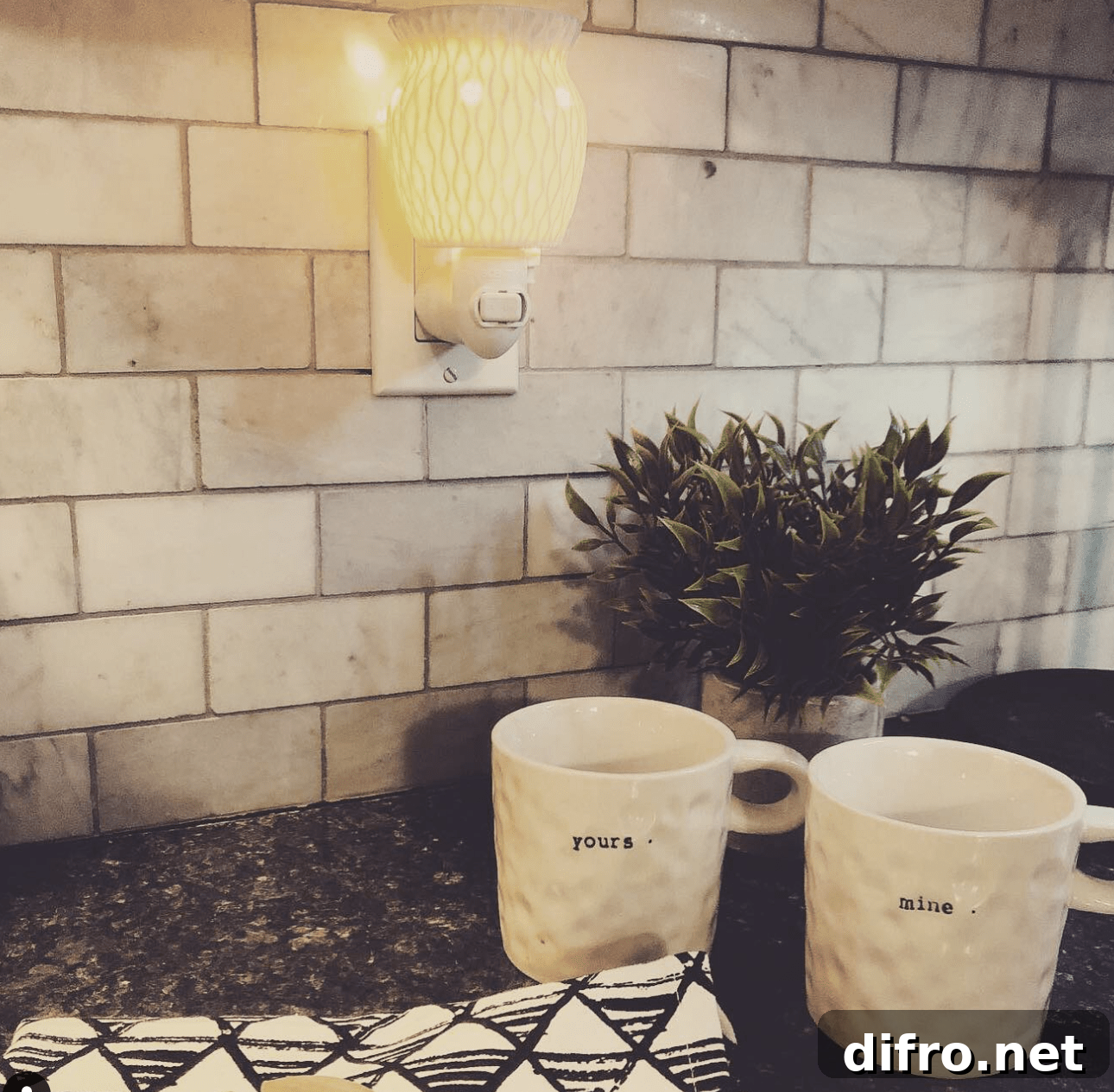 set of mug on black countertop with plug in scentsy