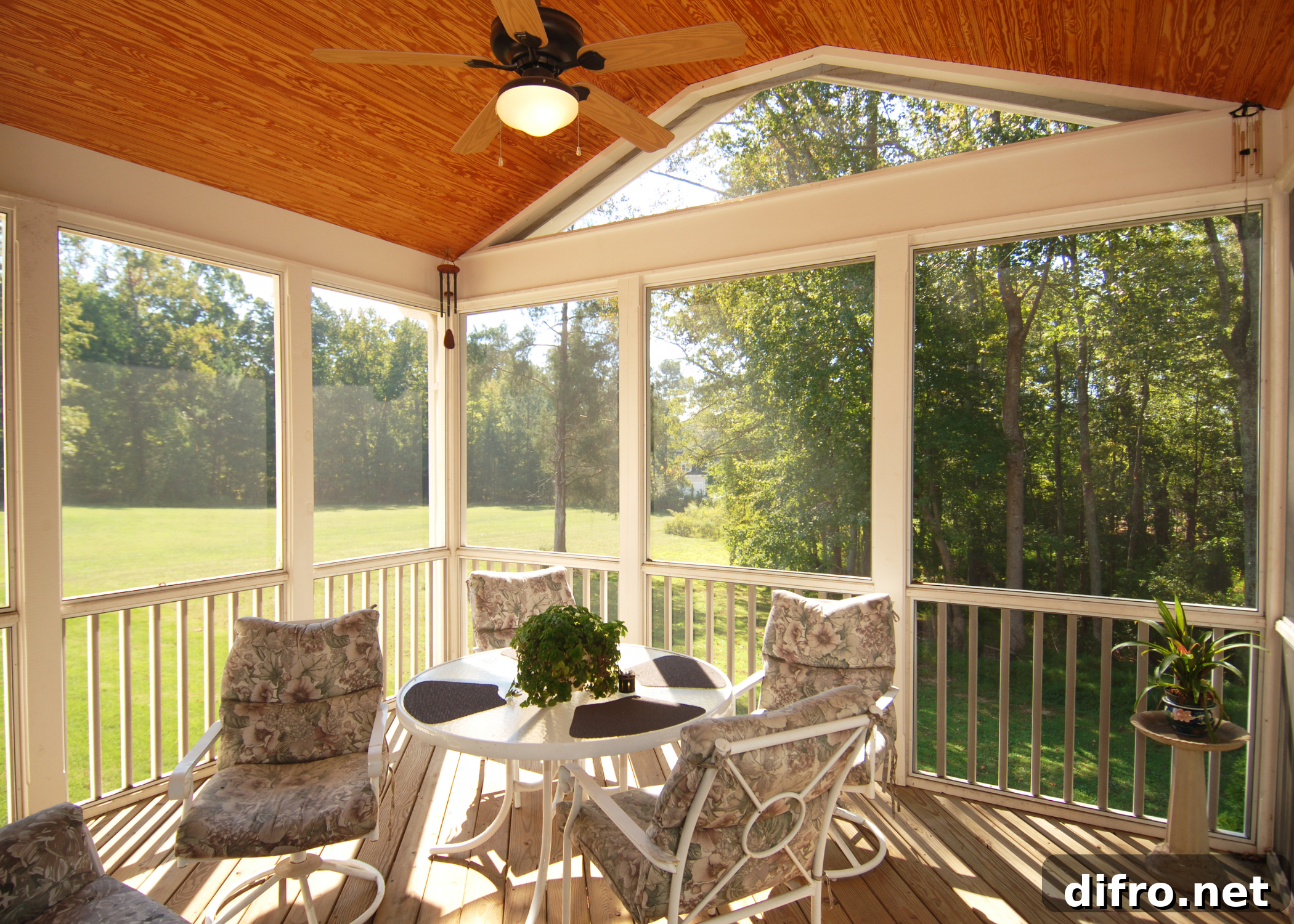 screened in porch with wood ceiling and white patio furniture