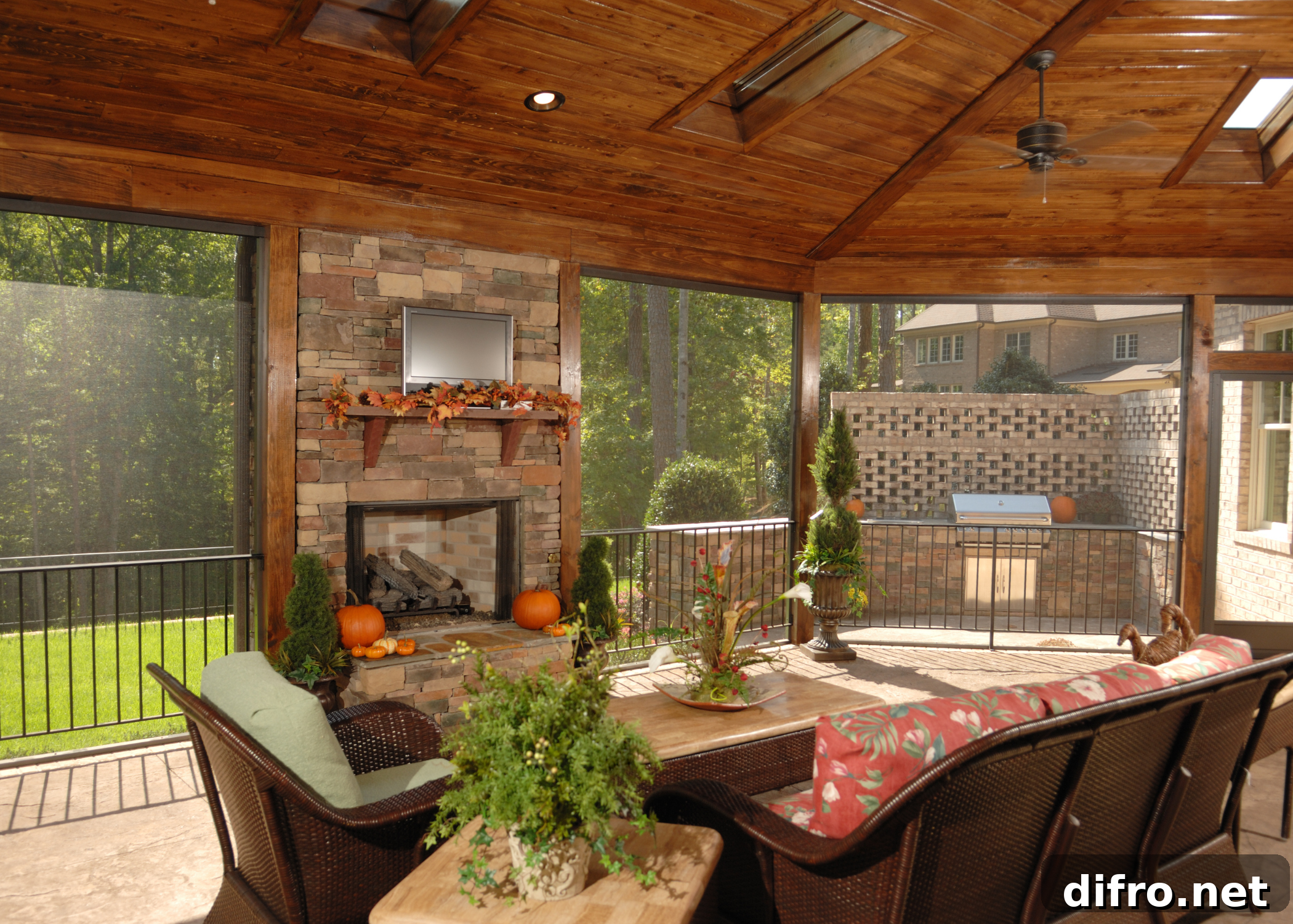 screened in patio with wood ceiling and brick fireplace