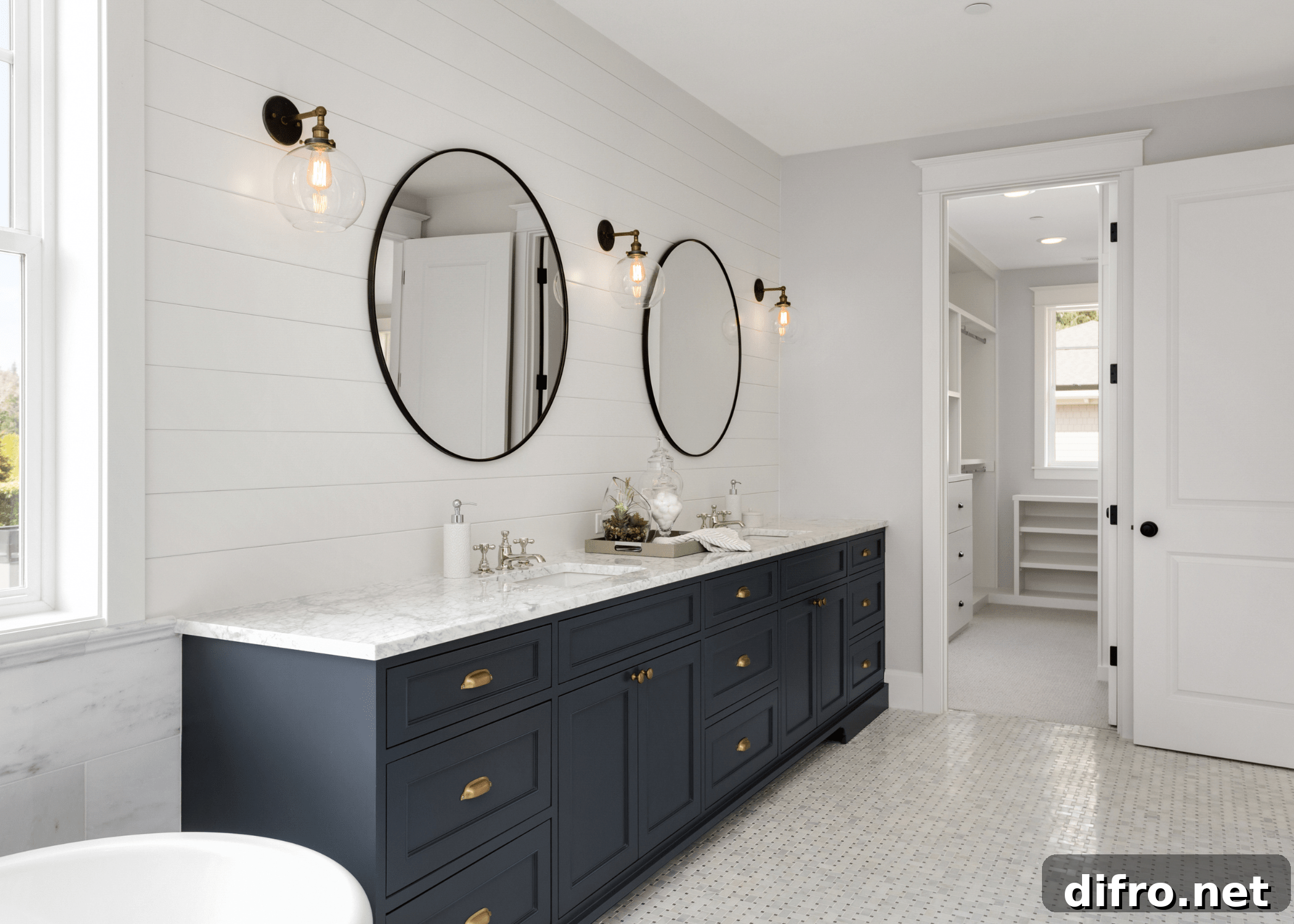 modern luxury bathroom with circle mirrors and dark colored vanity