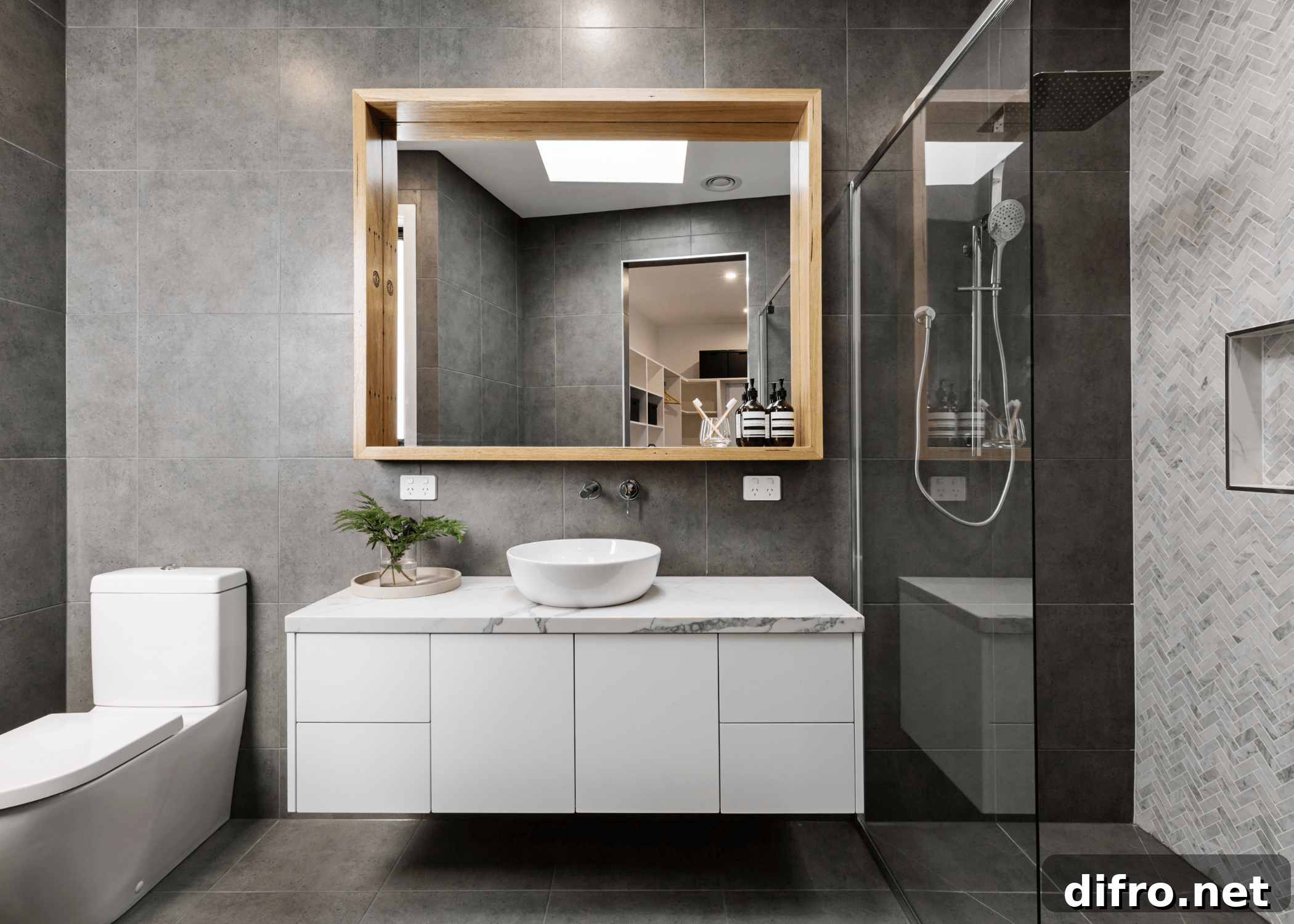grey modern bathroom with wood frame mirror and white floating vanity