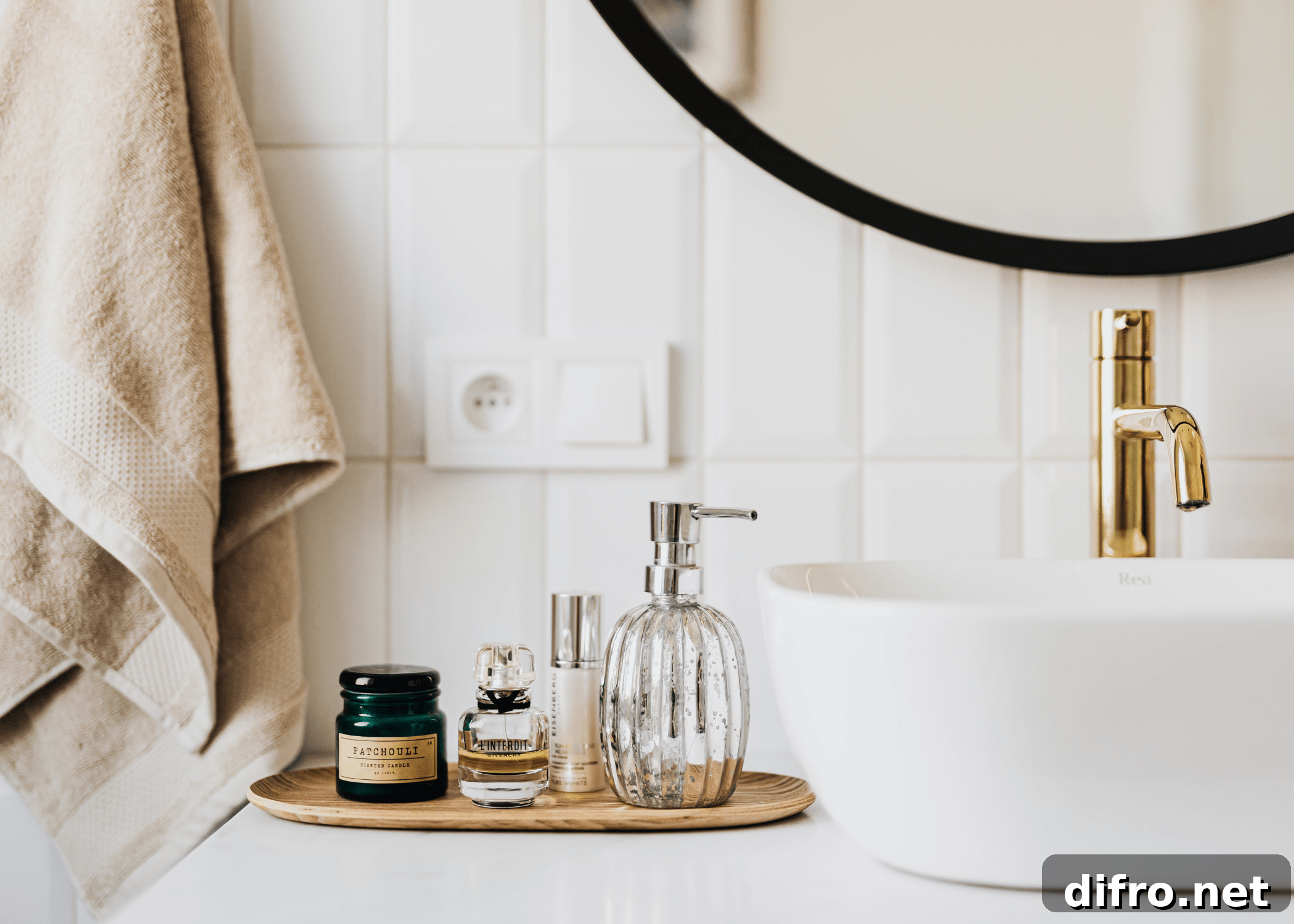 close up of bathroom sink with gold faucet and hand towel