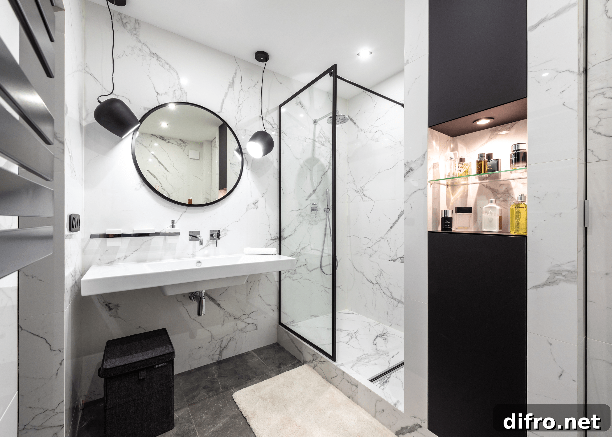 black and white bathroom with round circle mirror and walk in shower