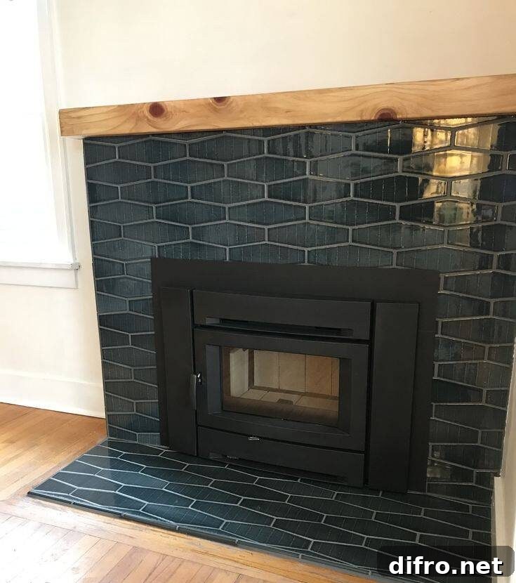 Teal colored fireplace tile with wooden shelf.