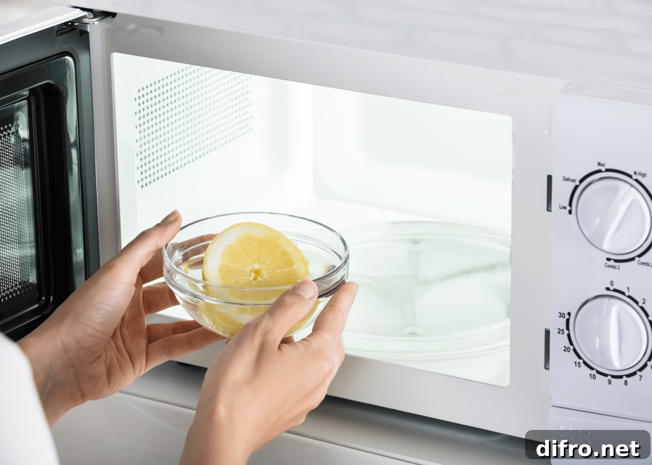 lemon in water being placed into microwave