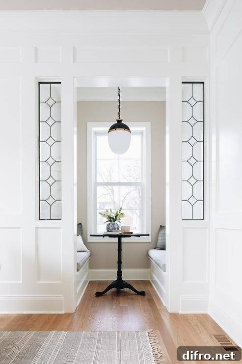 Peak through leaded glass panels into a keeping room with a black French table and built-in benches topped with gray cushions.