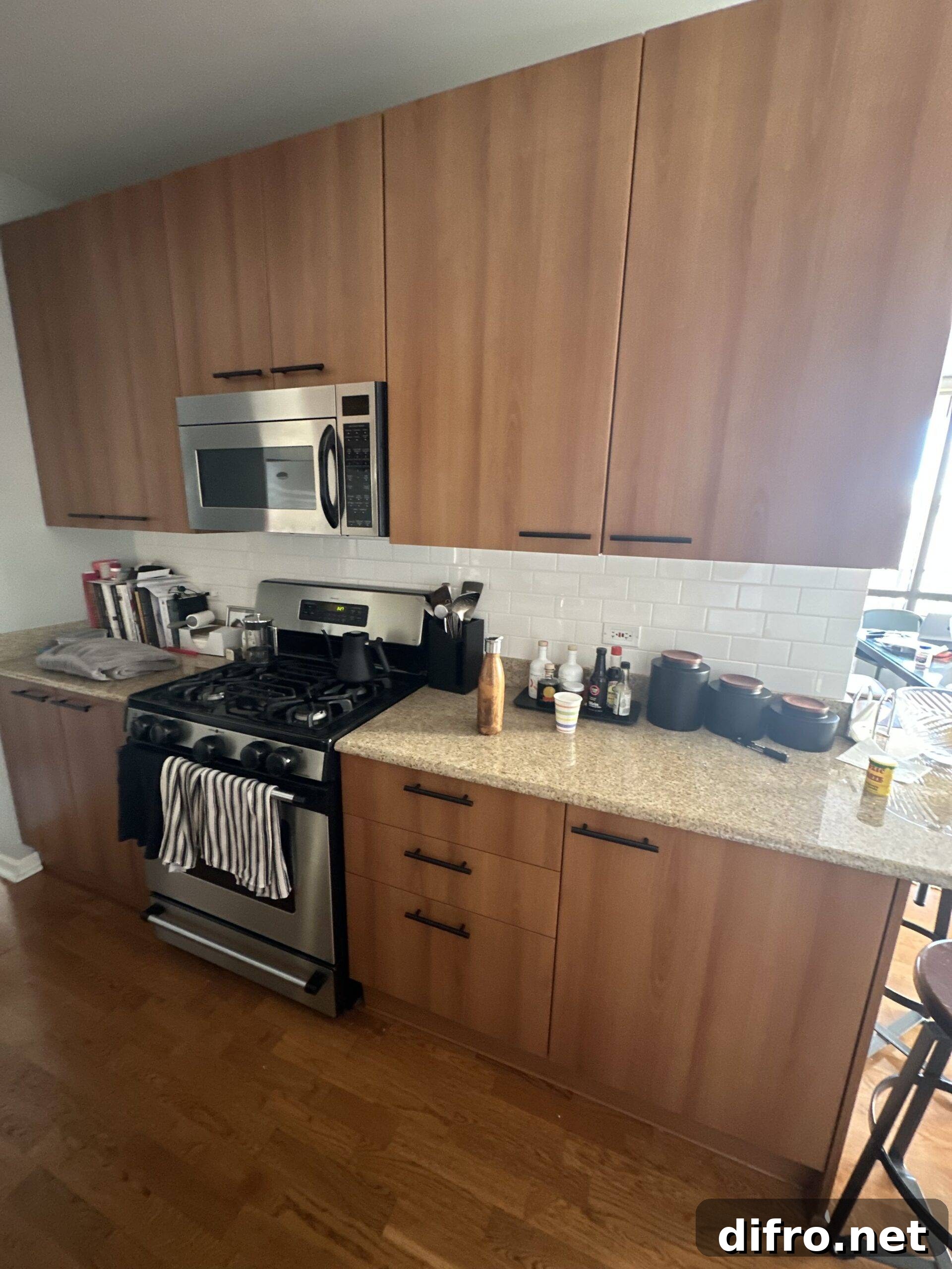 Outdated kitchen with wooden cabinets and flooring.