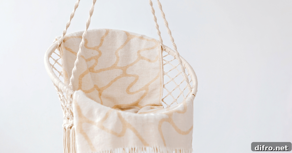 Hanging chair flanked by white wall.