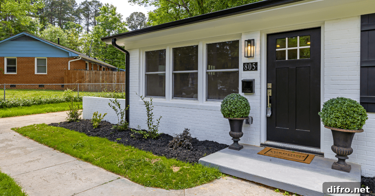 Small house with a large black front door.