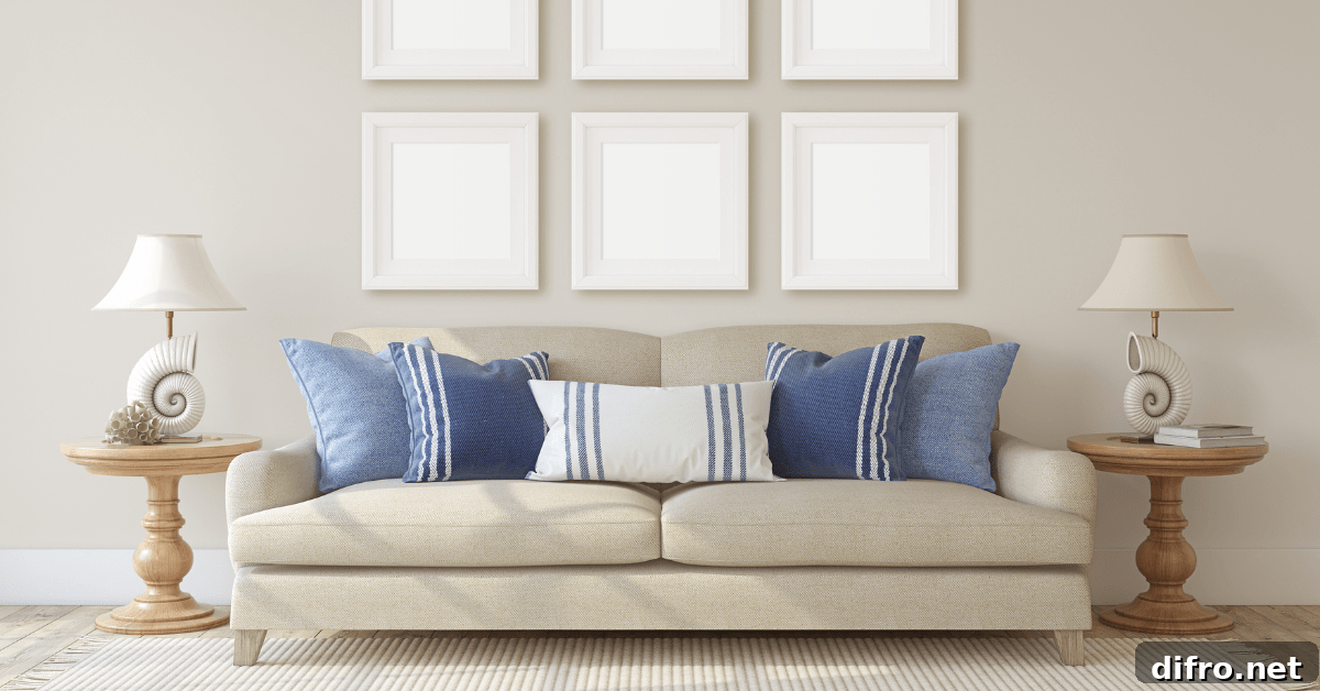 Beige couch with coast themed throw pillows.
