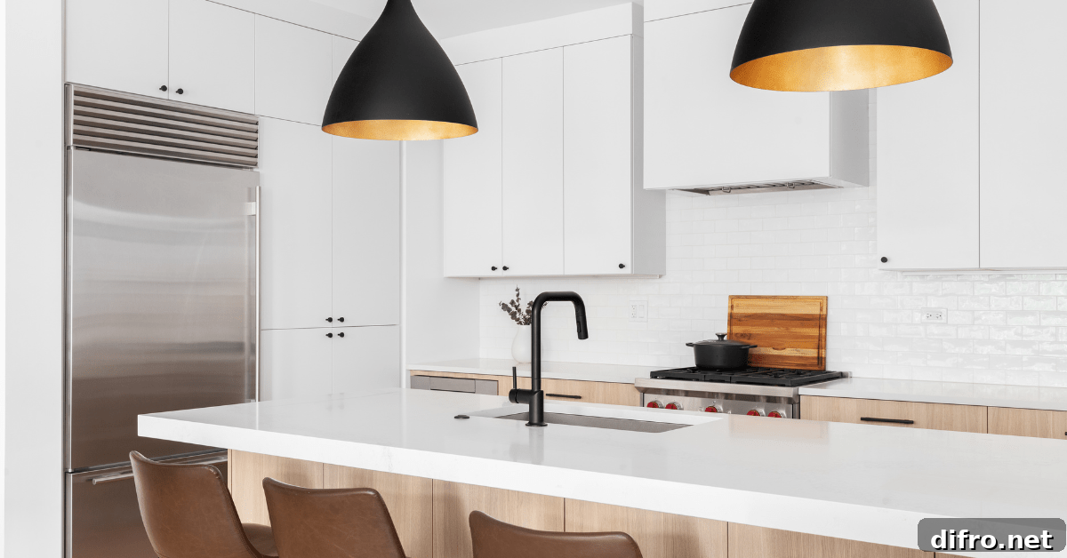 Overhead lighting in a modern kitchen with white cabinets.