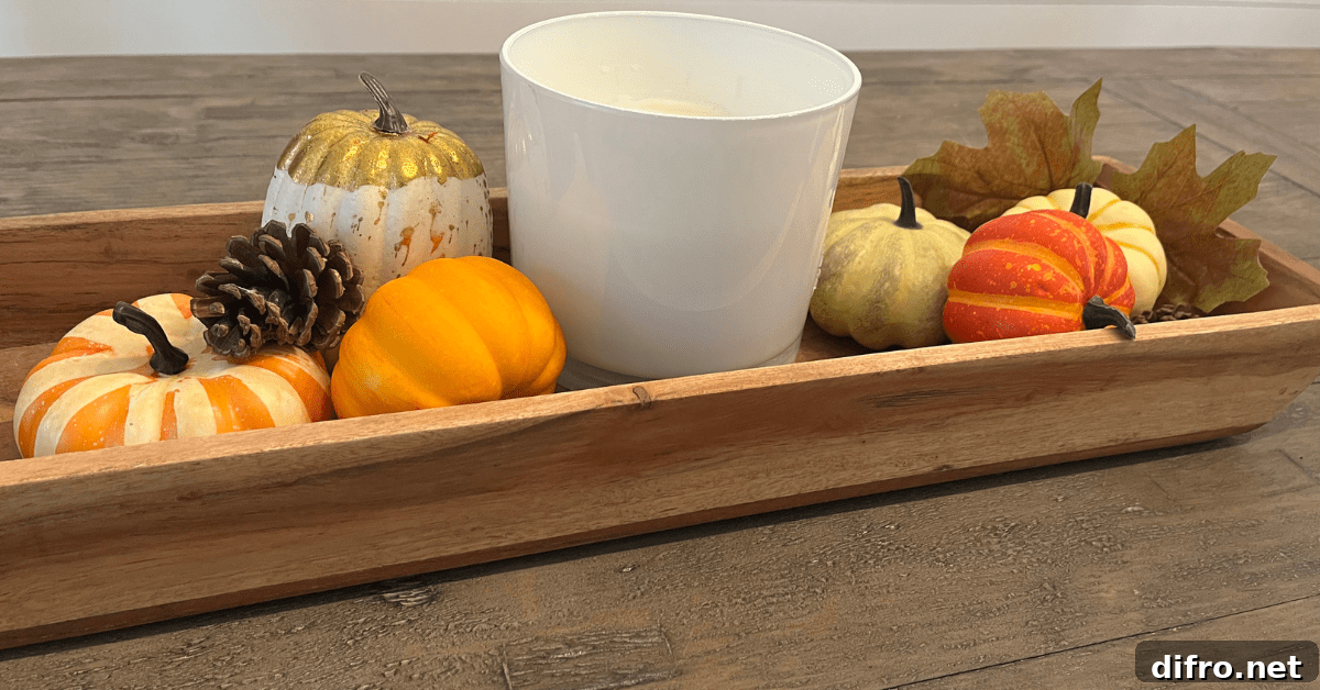 Wooden tray with candle and fall decor.
