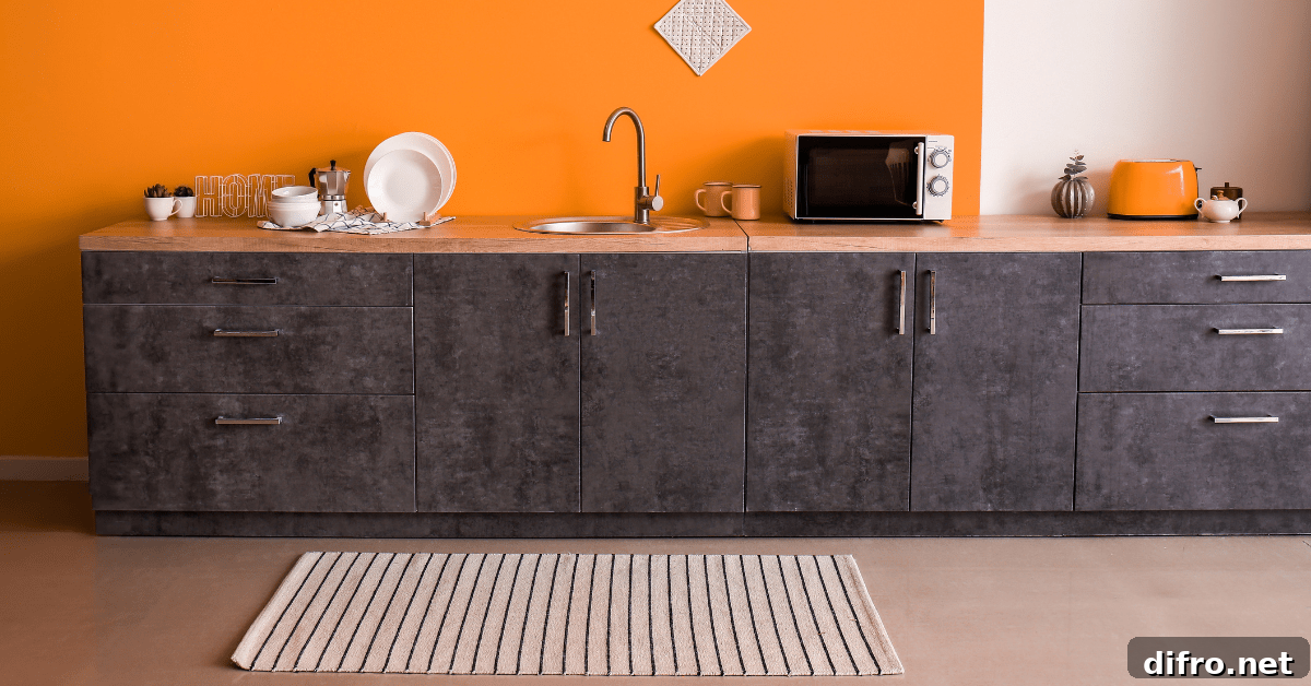 Orange wall in a kitchen with dark cabinets.