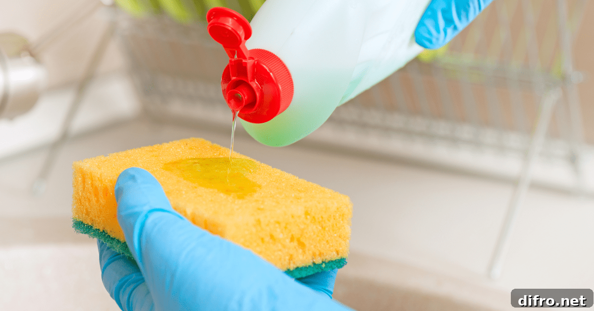 Person cleaning a sponge for dishes.