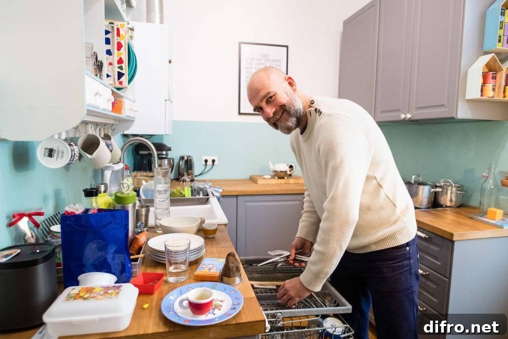 Man washing dishes while smiling
