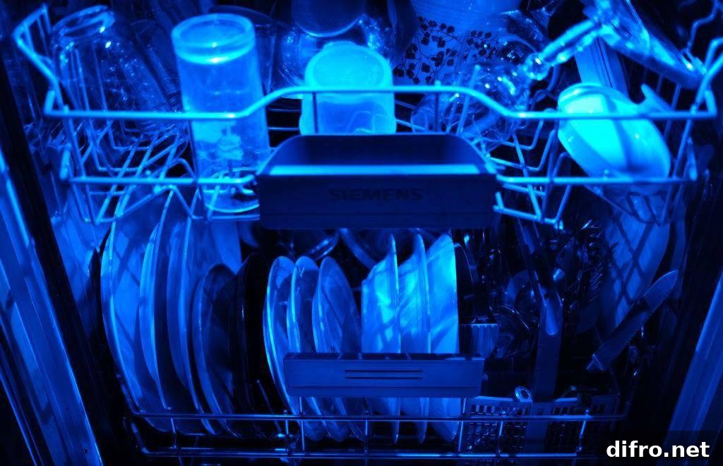 Washed dishes are in an open dishwasher with blue lighting