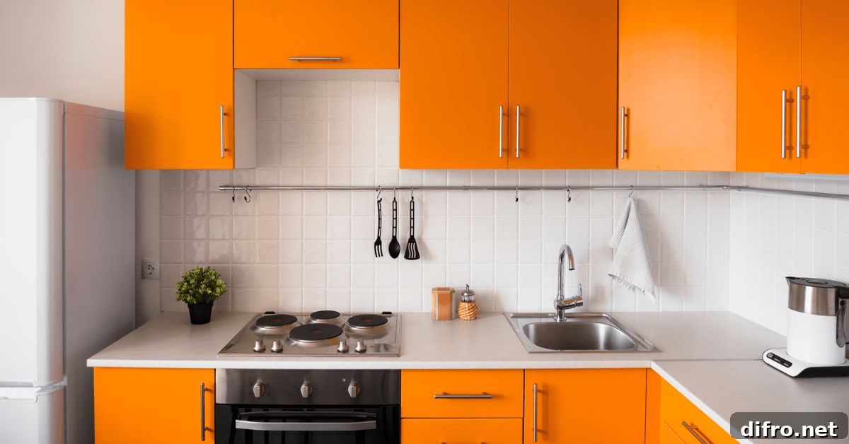 Modern kitchen with orange painted cabinets.