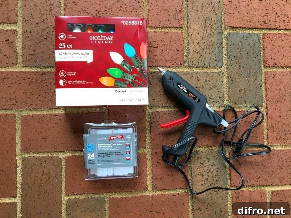 Hot glue beside a pack of Christmas lights.