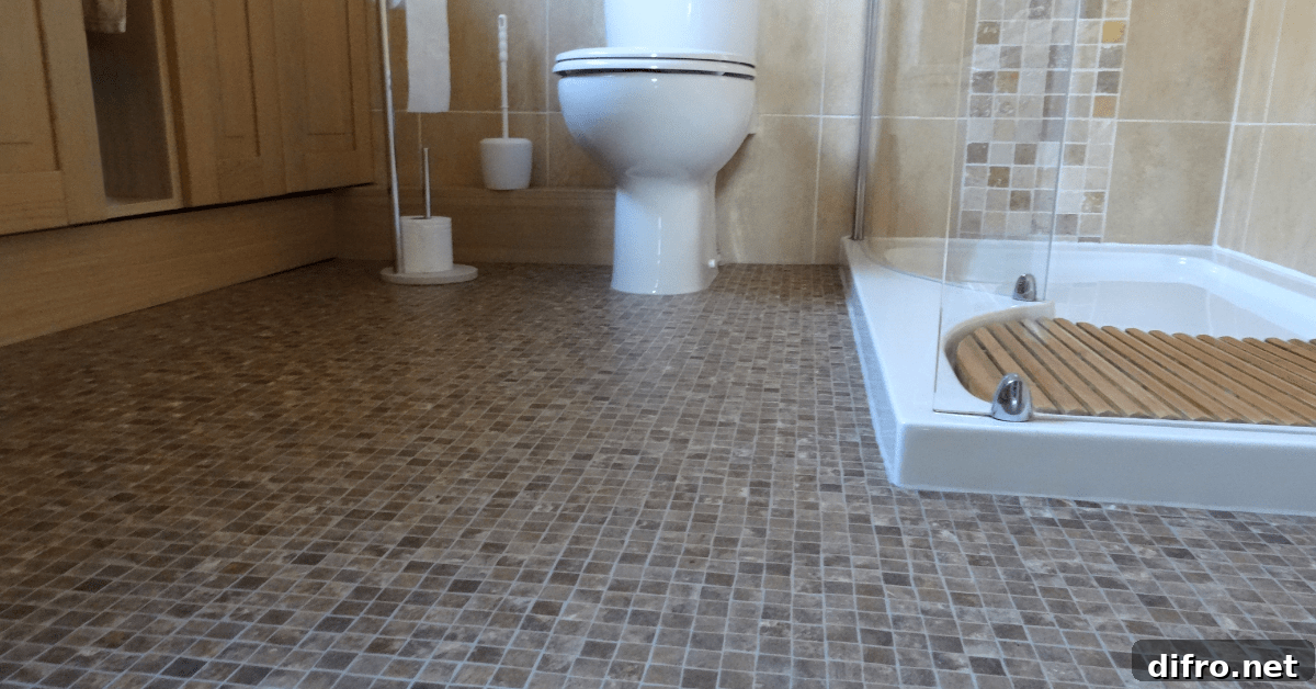 Bathroom with glass shower and mosaic tile.