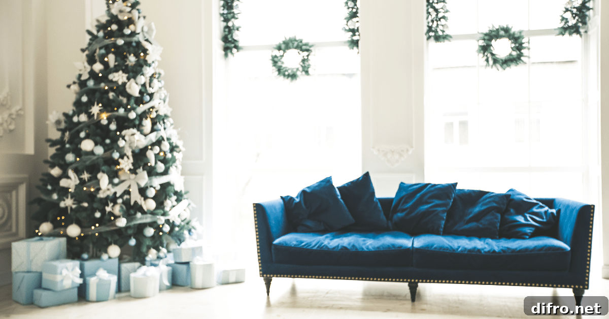 Blue velvet couch with Christmas tree in a living room.
