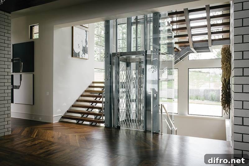Glass elevator with stairs surrounding it.
