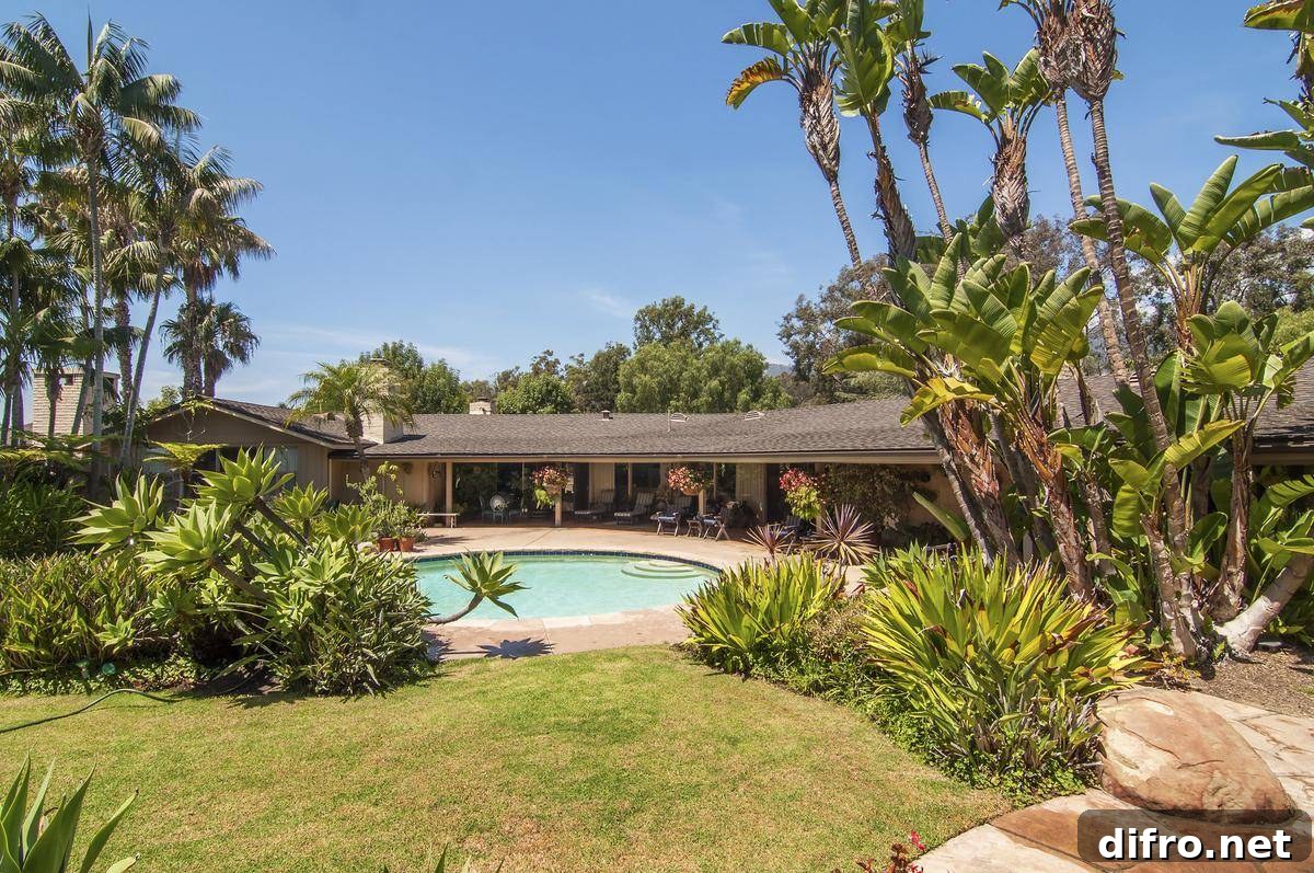 The backside of Oprah's house features her porch with the pool.