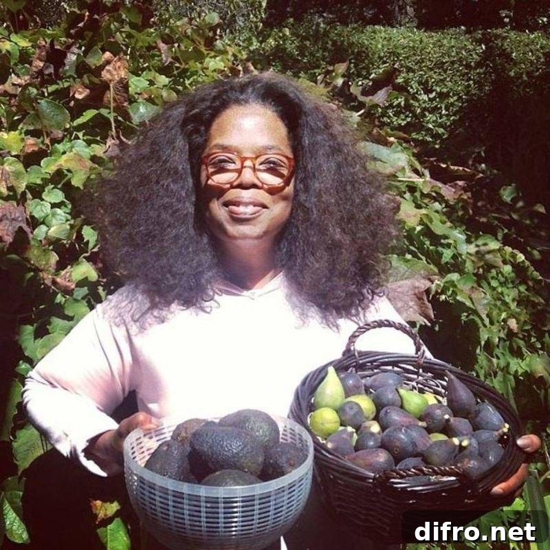 Oprah holding two bowls of avocados.