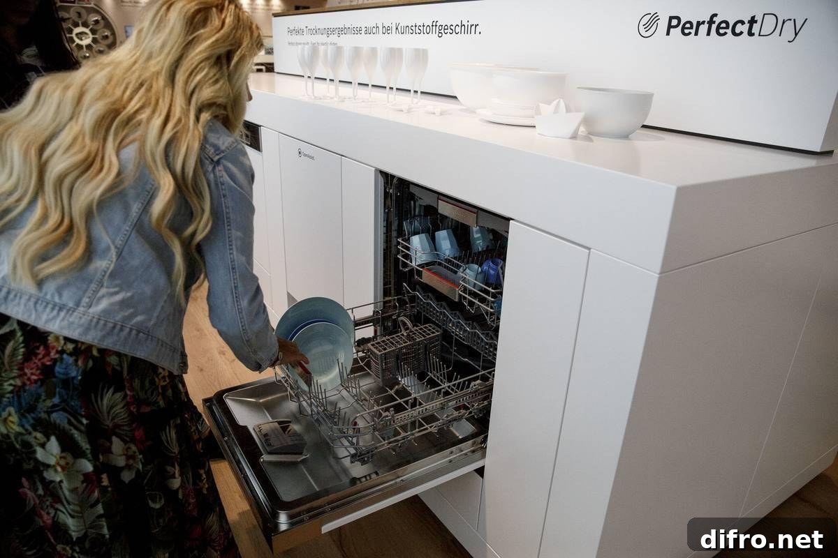 A woman loads her dishwasher.