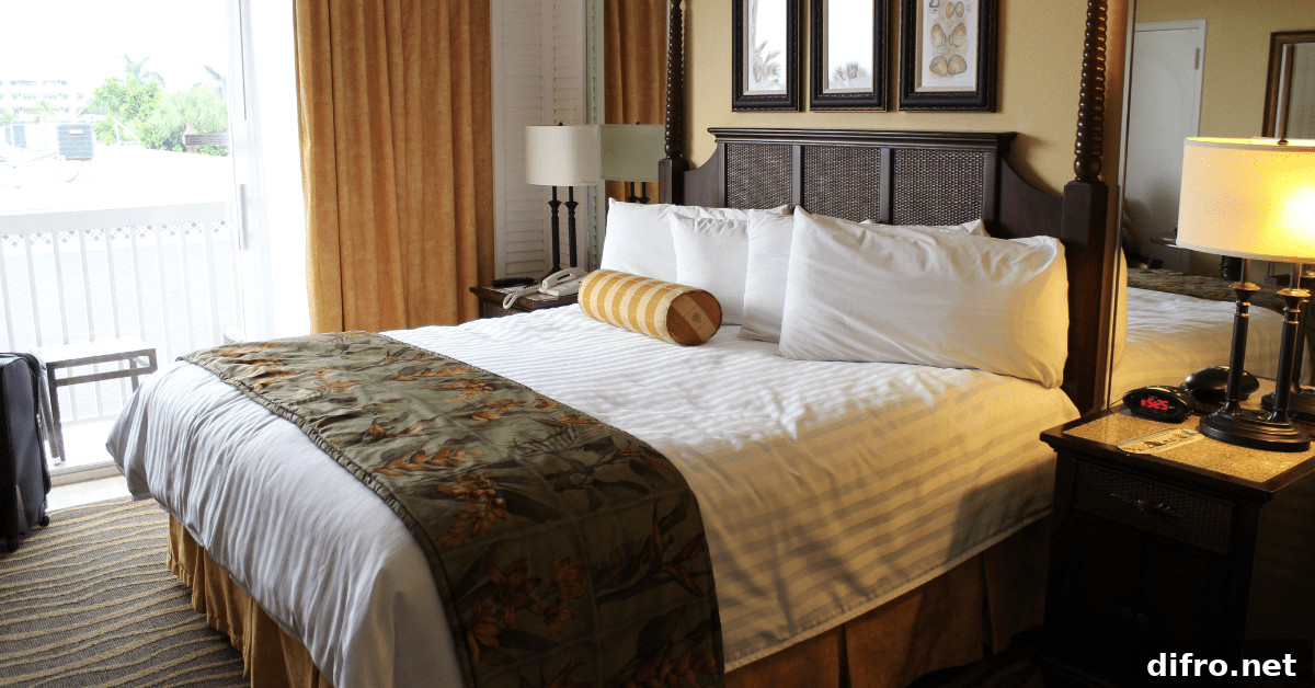 Large bed against a window in a traditional bedroom.