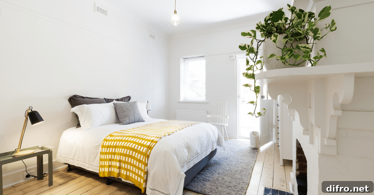 Modern bed with yellow throw blanket.
